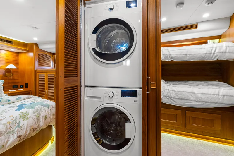  Yacht Photos Pics Stacked washer and dryer in luxurious 2023 Fleming 65 yacht cabin.
