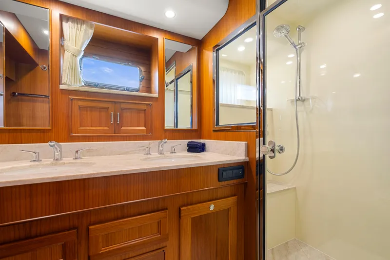  Yacht Photos Pics Luxurious bathroom in 2023 Fleming 65 yacht with dual sinks and glass shower.
