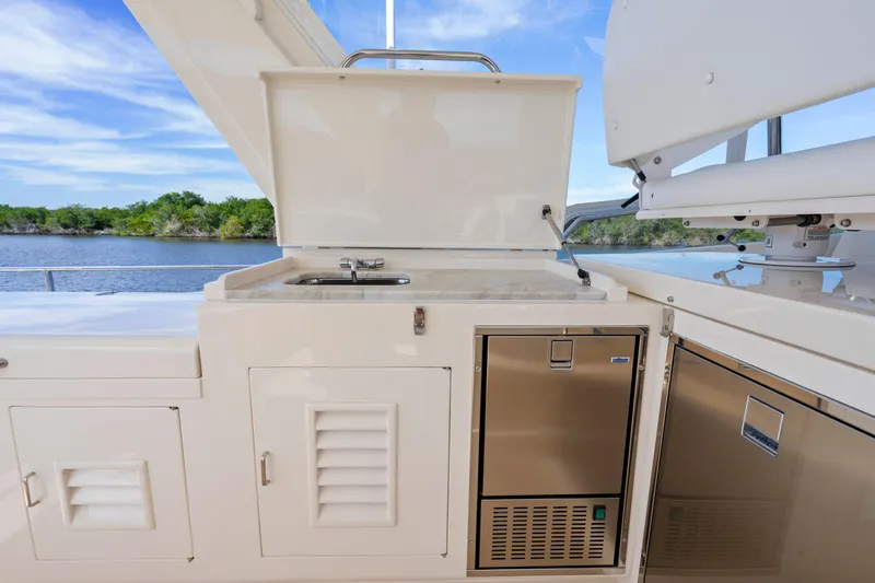  Yacht Photos Pics Outdoor kitchen on 2023 Fleming 65 yacht, featuring a sink and stainless steel appliances.