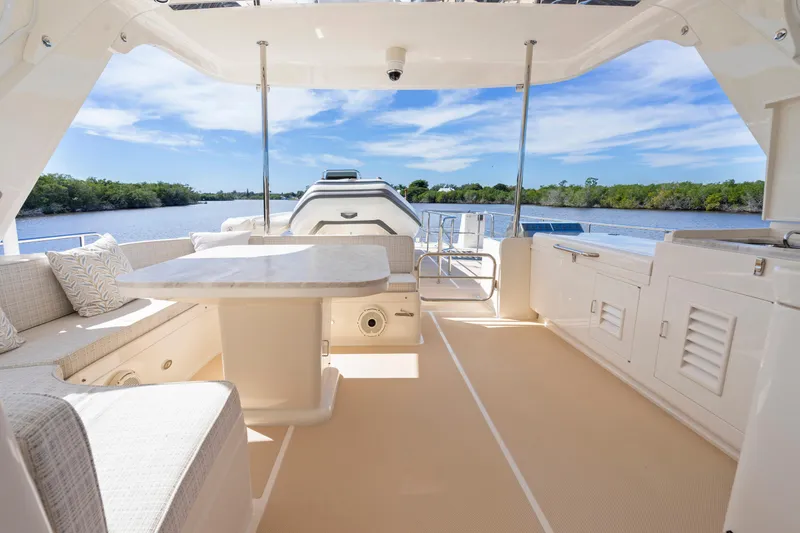  Yacht Photos Pics Luxurious 2023 Fleming 65 yacht interior with elegant seating and scenic water view.