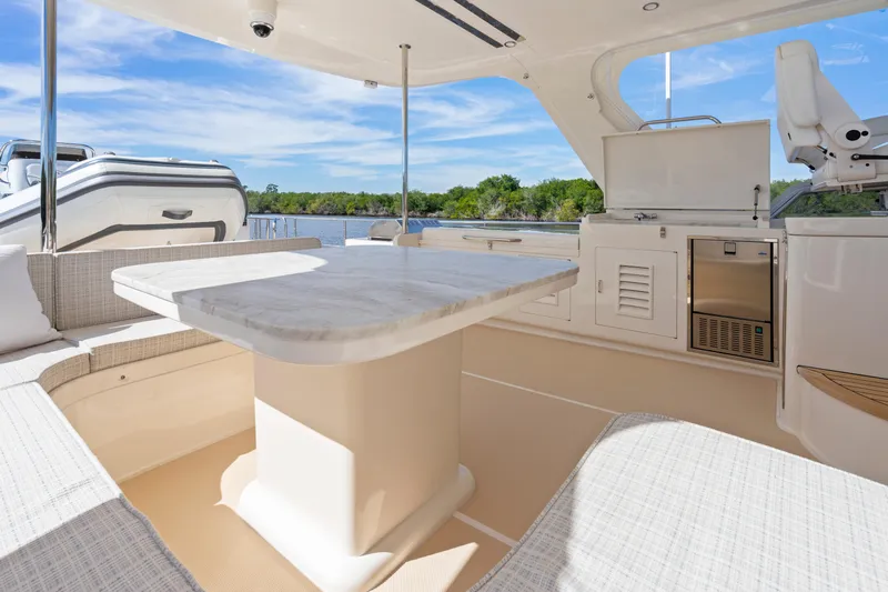  Yacht Photos Pics Luxurious 2023 Fleming 65 yacht interior with elegant seating and dining area.
