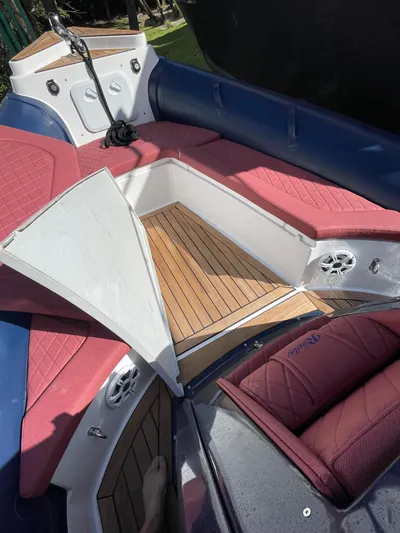  Yacht Photos Pics Interior of 2022 RIB 30 boat with red seating and wooden flooring.
