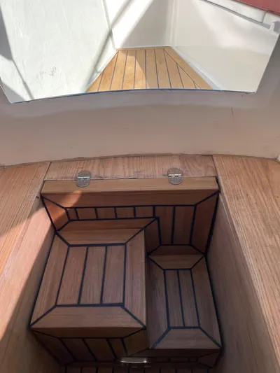  Yacht Photos Pics Wooden interior of 2022 RIB 30 boat, featuring sleek, modern design.