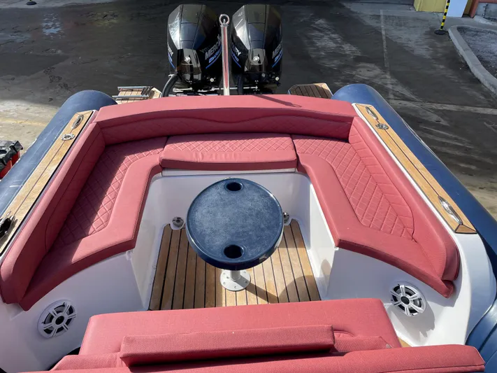  Yacht Photos Pics Red cushioned seating on a 2022 RIB 30 boat with dual engines.