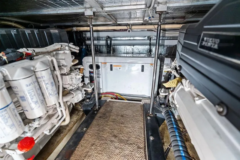 Time Out Yacht Photos Pics Engine room of a 2009 Carver 56 Voyager SE yacht, showcasing mechanical components.