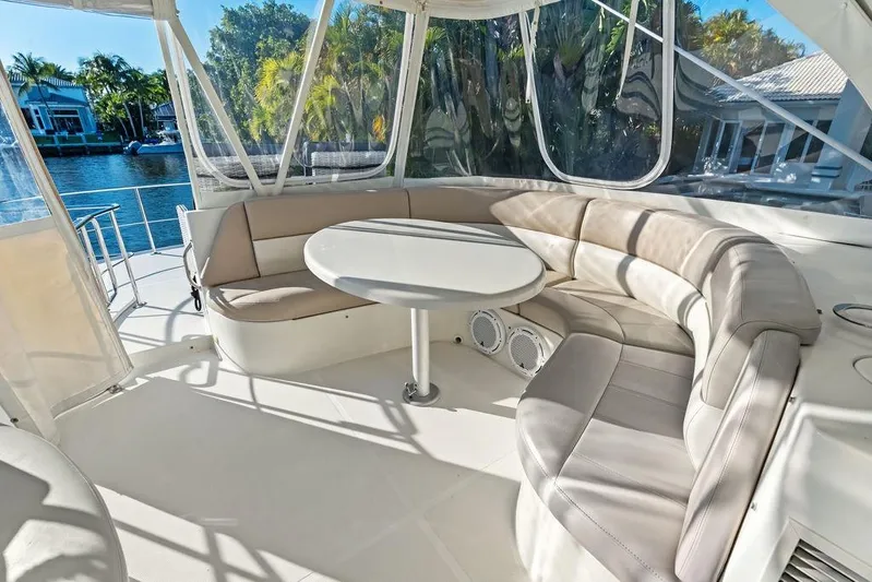 Time Out Yacht Photos Pics Luxurious seating area on a 2009 Carver 56 Voyager SE yacht, featuring a round table.