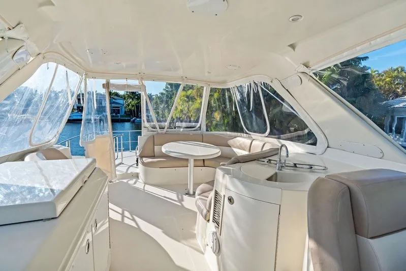 Time Out Yacht Photos Pics Luxurious interior of 2009 Carver 56 Voyager SE yacht with seating and kitchenette.