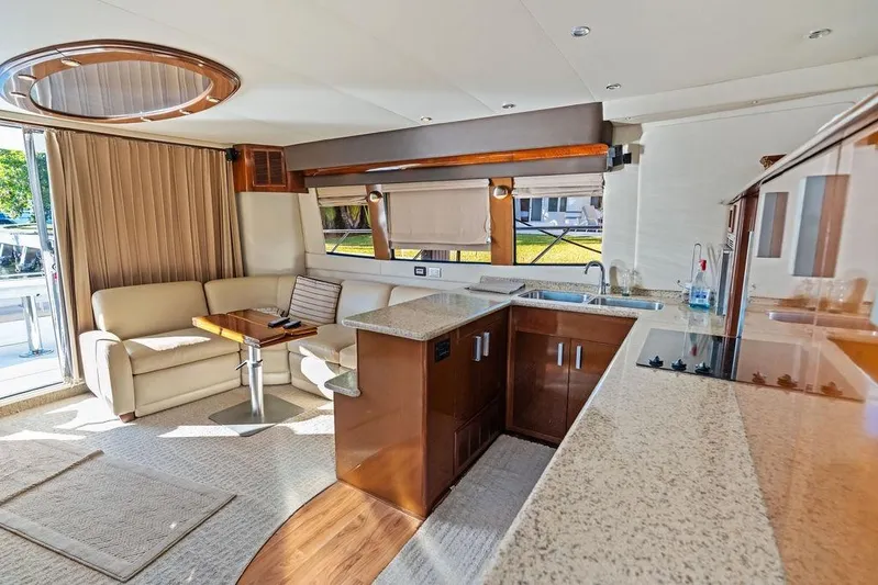Time Out Yacht Photos Pics Luxurious interior of 2009 Carver 56 Voyager SE yacht with modern kitchen and seating area.