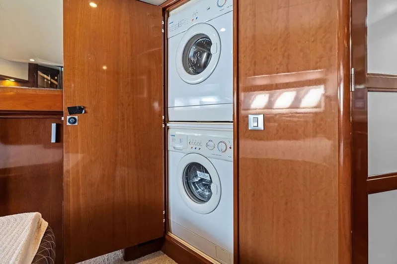 Time Out Yacht Photos Pics 2009 Carver 56 Voyager SE yacht with built-in washer and dryer in wooden cabinet.