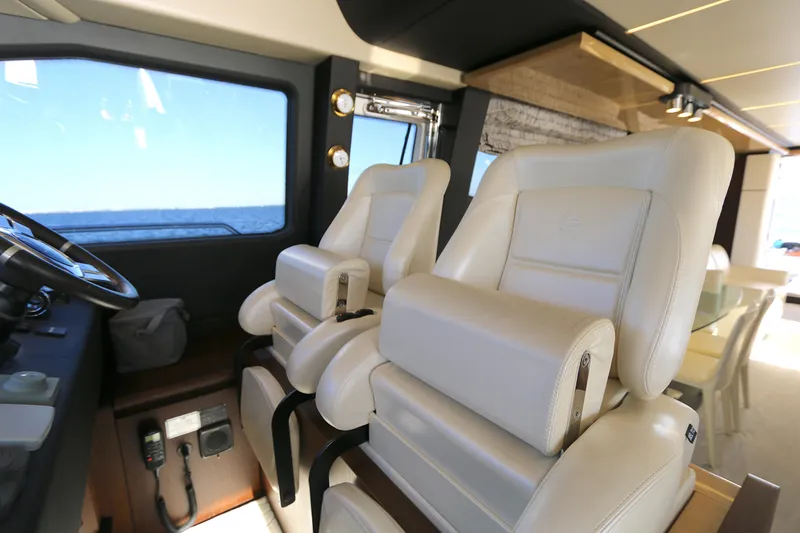 This Is It Yacht Photos Pics Luxurious interior of 2019 Azimut 72 Flybridge yacht with plush white seating.