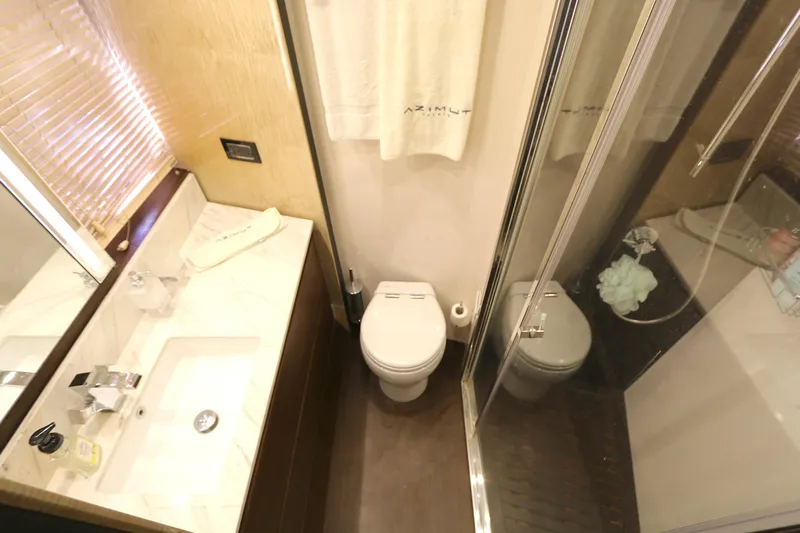 This Is It Yacht Photos Pics Luxurious bathroom in 2019 Azimut 72 Flybridge yacht with modern fixtures and shower.