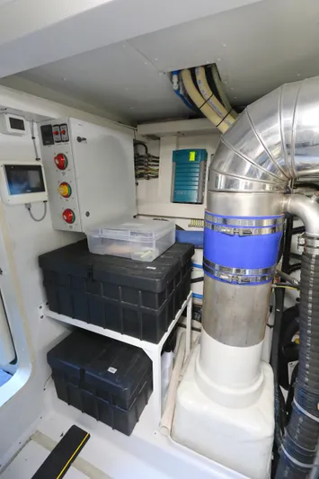 This Is It Yacht Photos Pics Engine room of 2019 Azimut 72 Flybridge yacht with control panels and storage boxes.