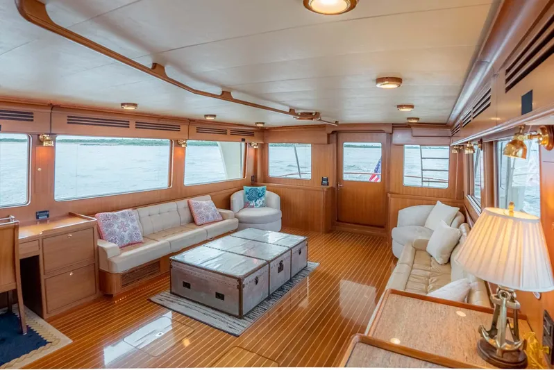 Someday Came Yacht Photos Pics Luxurious interior of 2006 Marlow 72E LRC yacht with elegant seating and wooden flooring.