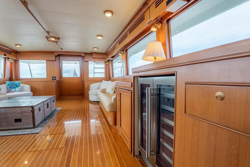 Someday Came Yacht Photos Pics Luxurious interior of 2006 Marlow 72E LRC yacht with wooden flooring and modern furnishings.