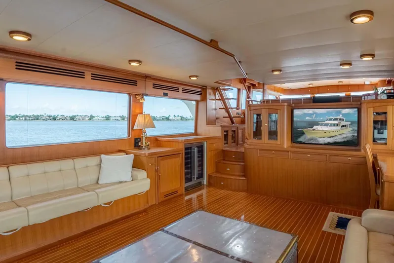 Someday Came Yacht Photos Pics Luxurious interior of 2006 Marlow 72E LRC yacht with elegant wood finishes and spacious seating.