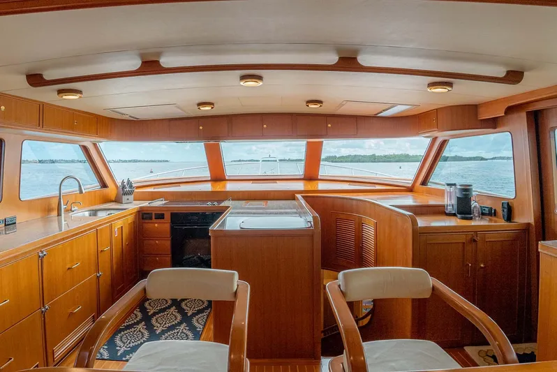 Someday Came Yacht Photos Pics Luxurious interior of 2006 Marlow 72E LRC yacht with panoramic windows and elegant wood finish.