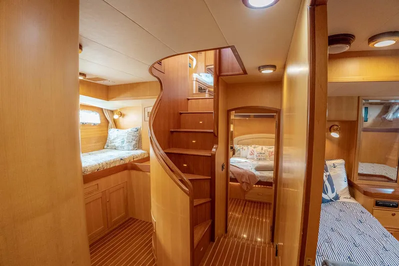 Someday Came Yacht Photos Pics Luxurious 2006 Marlow 72E LRC yacht interior with wooden staircase and cozy cabins.