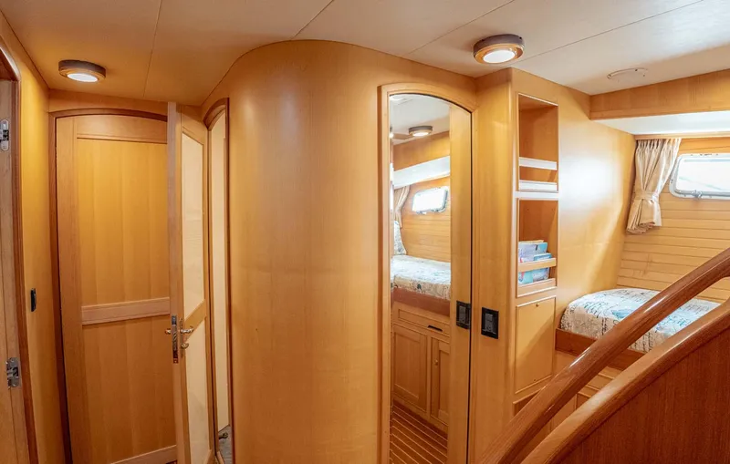 Someday Came Yacht Photos Pics Luxurious 2006 Marlow 72E LRC yacht interior with wooden finishes and cozy cabin.