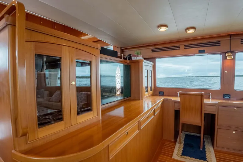 Someday Came Yacht Photos Pics Luxurious interior of 2006 Marlow 72E LRC yacht with wooden cabinetry and ocean view.