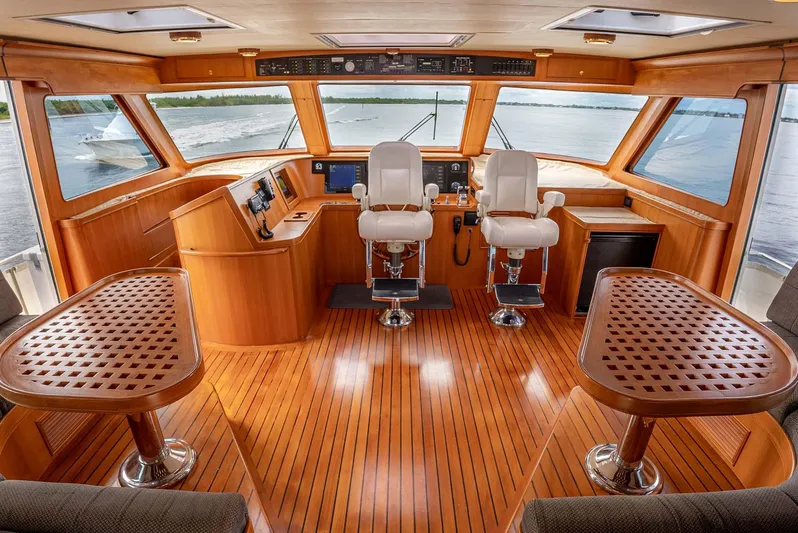 Someday Came Yacht Photos Pics Luxurious 2006 Marlow 72E LRC yacht interior with wooden flooring and dual helm chairs.