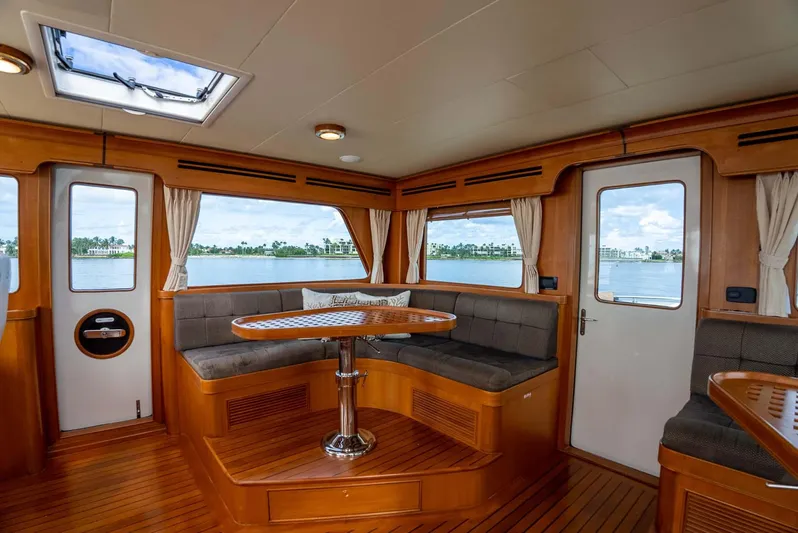 Someday Came Yacht Photos Pics Interior of 2006 Marlow 72E LRC yacht with wood finish and panoramic windows.