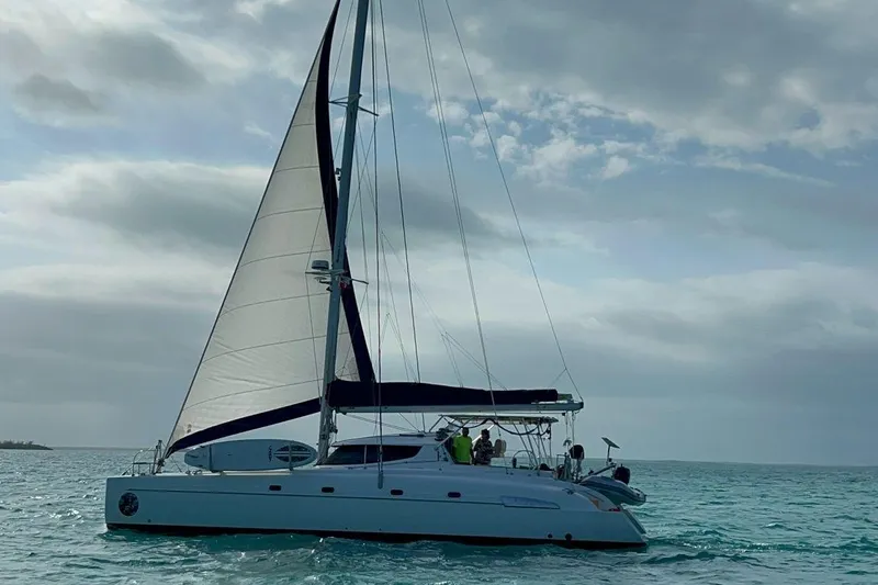 Thalassa Yacht Photos Pics 2005 Fountaine Pajot Bahia 46 catamaran sailing on open sea under cloudy sky.