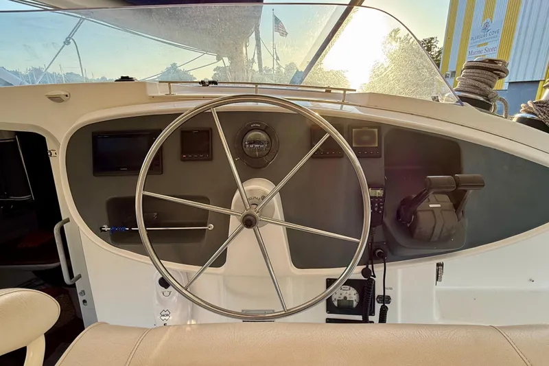 Thalassa Yacht Photos Pics Helm of 2005 Fountaine Pajot Bahia 46 catamaran with steering wheel and navigation instruments.
