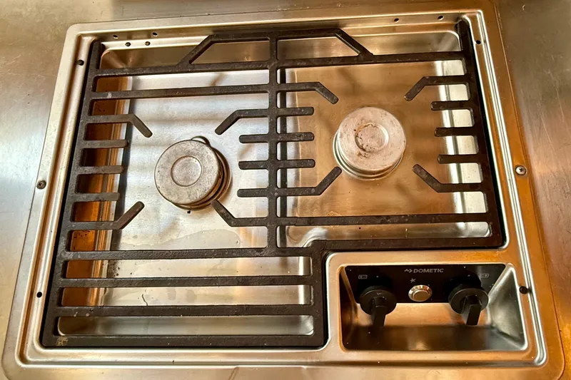 Thalassa Yacht Photos Pics Stainless steel stove on 2005 Fountaine Pajot Bahia 46 catamaran, featuring two burners and control knobs.