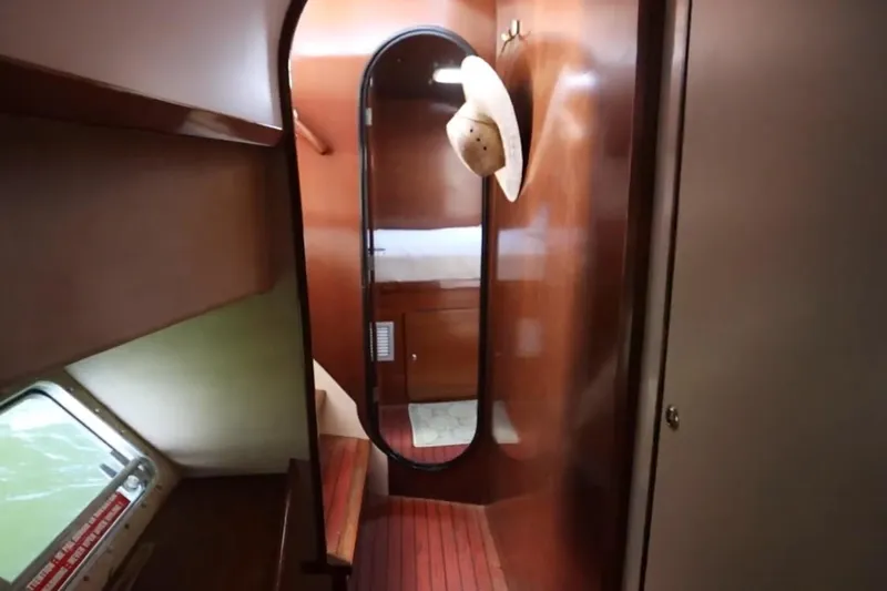 Thalassa Yacht Photos Pics Interior of 2005 Fountaine Pajot Bahia 46 yacht, featuring wooden paneling and a hat on a hook.