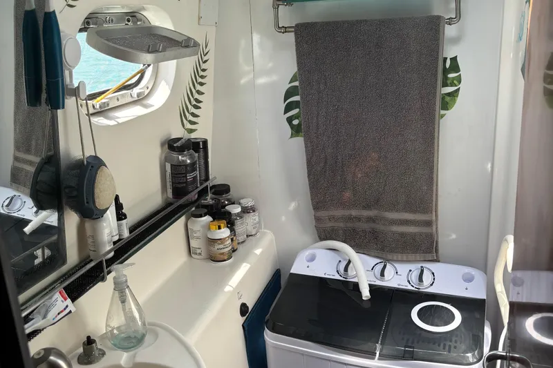 Thalassa Yacht Photos Pics Bathroom interior of 2005 Fountaine Pajot Bahia 46 catamaran with toiletries and washing machine.