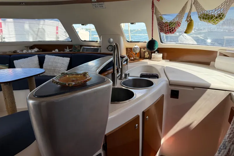 Thalassa Yacht Photos Pics Interior of 2005 Fountaine Pajot Bahia 46 catamaran with kitchen and seating area.