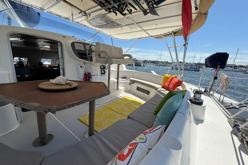 Thalassa Yacht Photos Pics Spacious deck of 2005 Fountaine Pajot Bahia 46 catamaran with colorful cushions and ocean view.