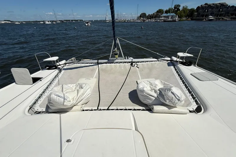 Thalassa Yacht Photos Pics 2005 Fountaine Pajot Bahia 46 catamaran deck with netting and cushions on a sunny day.