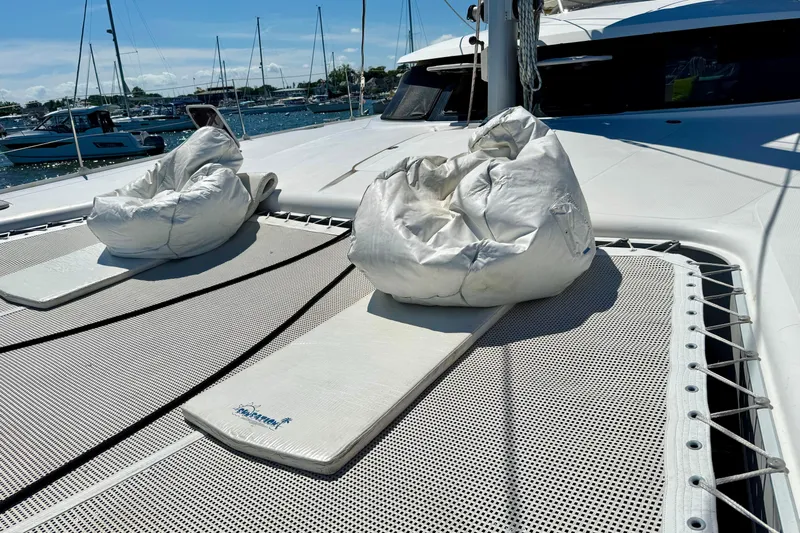 Thalassa Yacht Photos Pics 2005 Fountaine Pajot Bahia 46 catamaran with bean bags on deck, docked in marina.