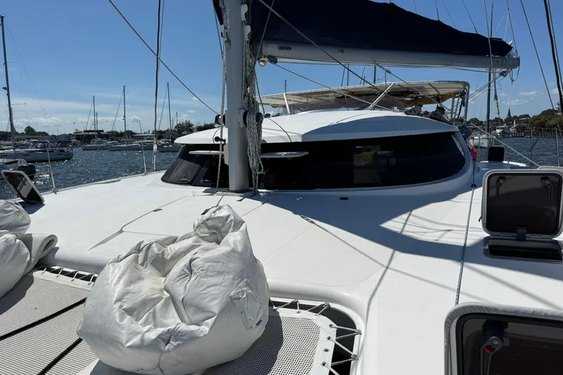 Thalassa Yacht Photos Pics 2005 Fountaine Pajot Bahia 46 catamaran docked in a marina under clear skies.