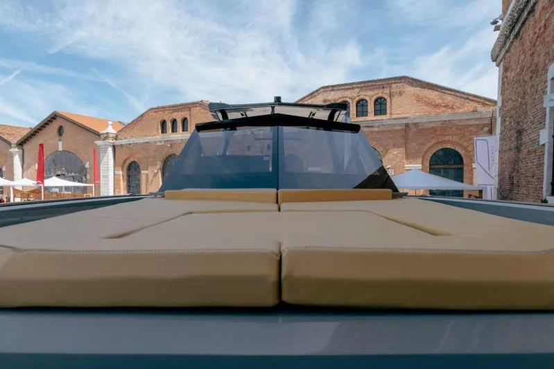 Evo R4 Wa Yacht Photos Pics 2024 Evo Yachts R4 WA luxury yacht with sunbathing deck, docked near historic buildings.