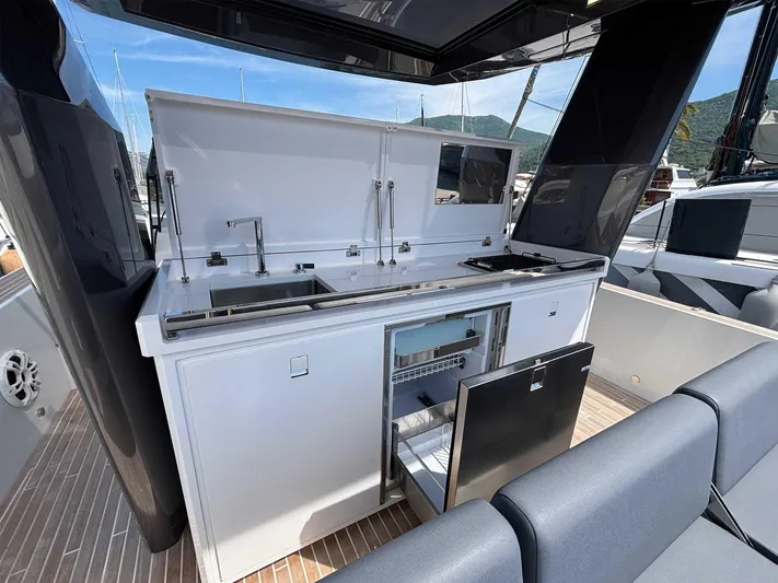 Barbarossa Yacht Photos Pics Outdoor kitchen on 2024 Fiart 43 Seawalker yacht, featuring sink, grill, and storage.