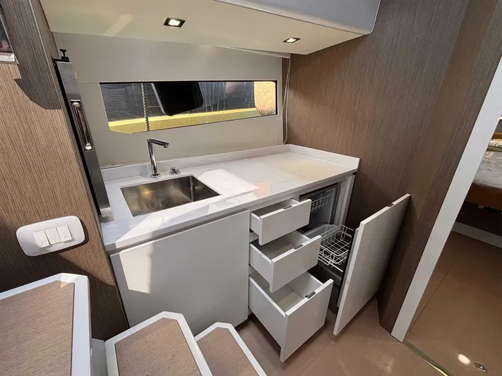 Barbarossa Yacht Photos Pics 2024 Fiart 43 Seawalker interior kitchen with modern sink, drawers, and dishwasher.