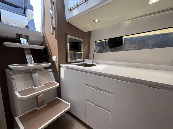 Barbarossa Yacht Photos Pics Modern kitchen interior of 2024 Fiart 43 Seawalker yacht with sleek cabinetry and stairs.