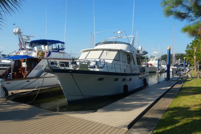 God's Favor Yacht Photos Pics 1986 DeFever 53 POC yacht docked at marina under clear blue sky.