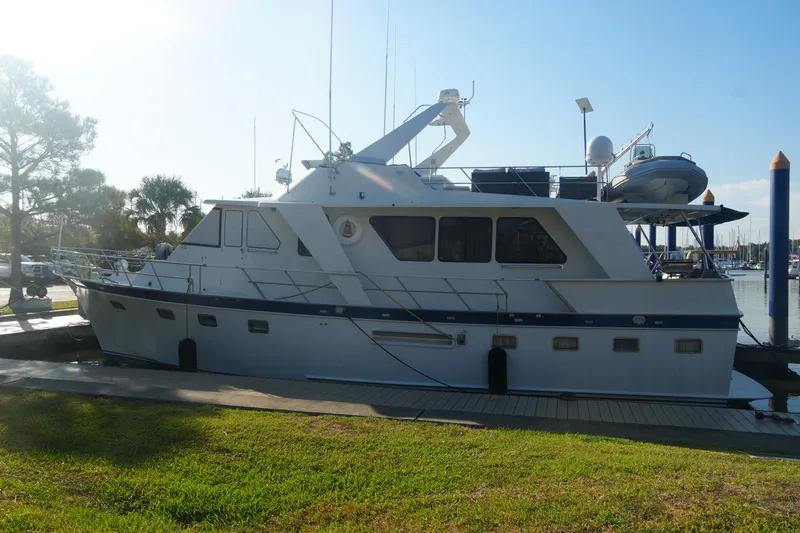 God's Favor Yacht Photos Pics 1986 DeFever 53 POC yacht docked at marina under clear blue sky.
