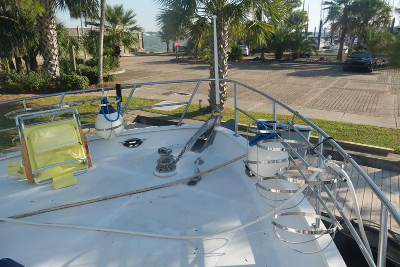 God's Favor Yacht Photos Pics 1986 DeFever 53 POC yacht deck with safety equipment and palm trees in the background.