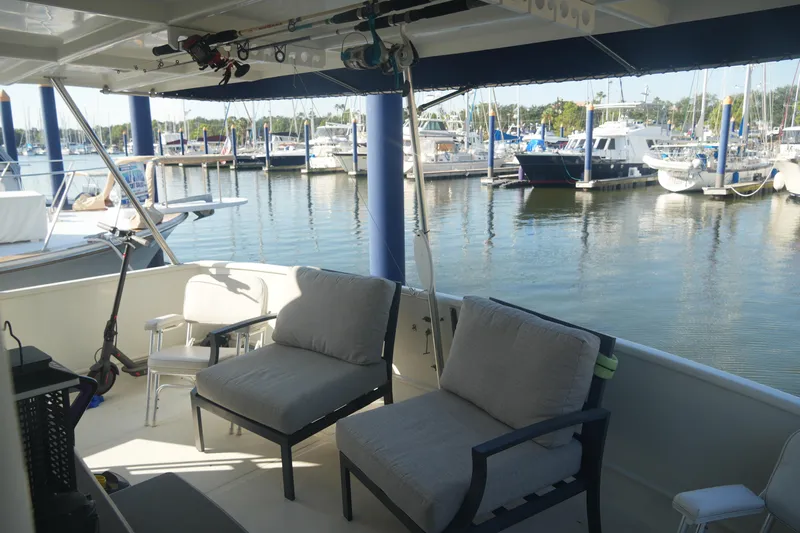 God's Favor Yacht Photos Pics 1986 DeFever 53 POC yacht deck with comfortable seating at marina.