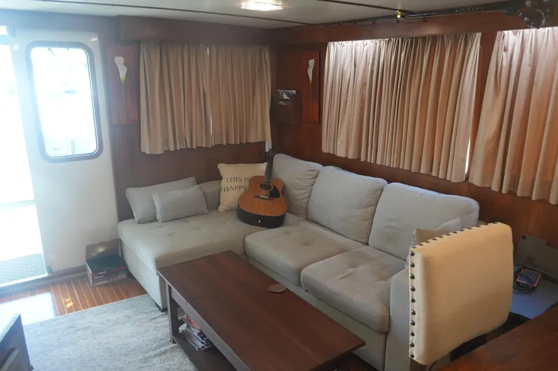 God's Favor Yacht Photos Pics Interior of 1986 DeFever 53 POC yacht with cozy seating and guitar.