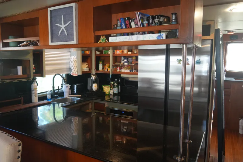 God's Favor Yacht Photos Pics 1986 DeFever 53 POC yacht kitchen with modern appliances and wooden cabinetry.