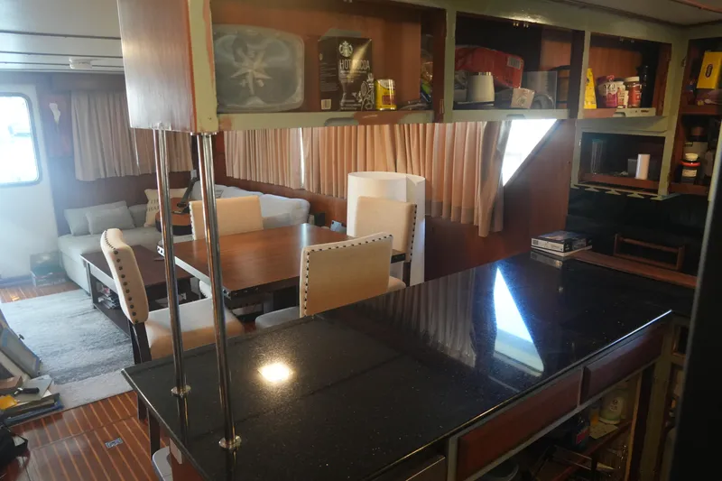 God's Favor Yacht Photos Pics Interior of 1986 DeFever 53 POC yacht with dining area and kitchen counter.