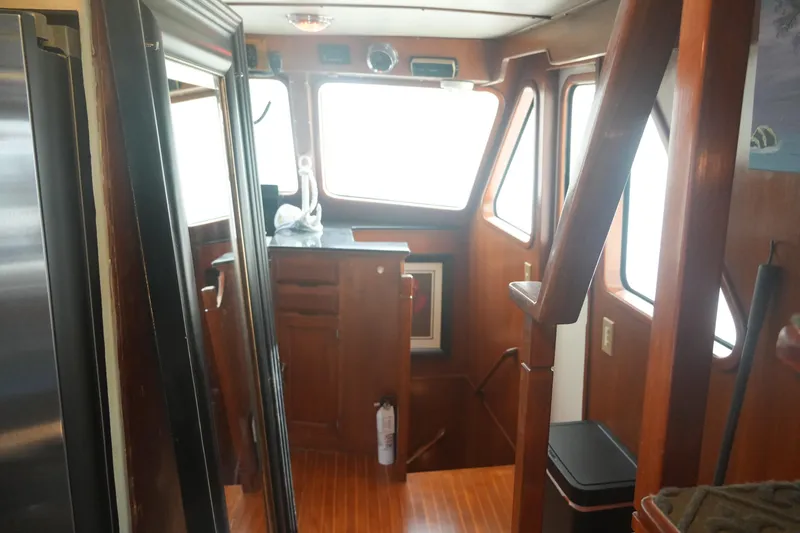 God's Favor Yacht Photos Pics Interior of 1986 DeFever 53 POC yacht with wooden finishes and windows.