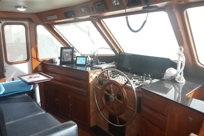 God's Favor Yacht Photos Pics 1986 DeFever 53 POC yacht helm with wooden steering wheel and navigation equipment.