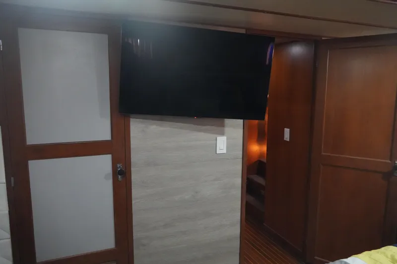 God's Favor Yacht Photos Pics Interior of 1986 DeFever 53 POC yacht with mounted TV and wooden doors.