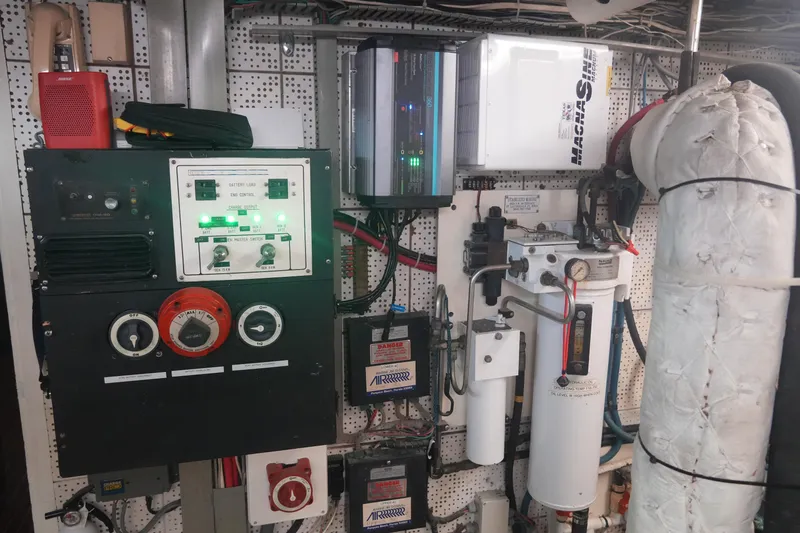 God's Favor Yacht Photos Pics Engine room of a 1986 DeFever 53 POC yacht with control panels and equipment.